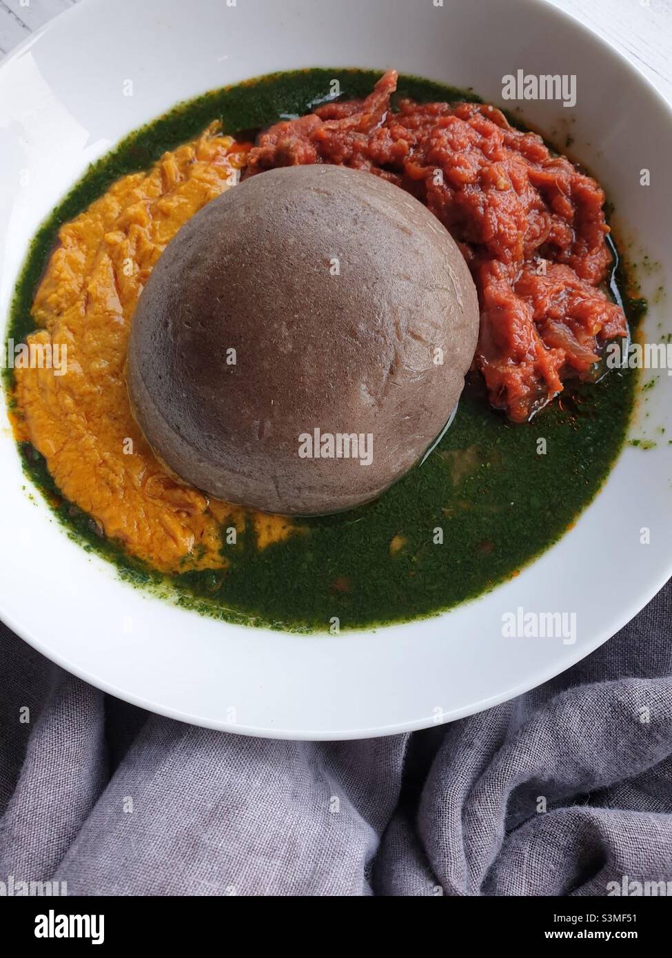 Amala, a dried yam paste dumpling, and abula. Abula is a trio of sauces