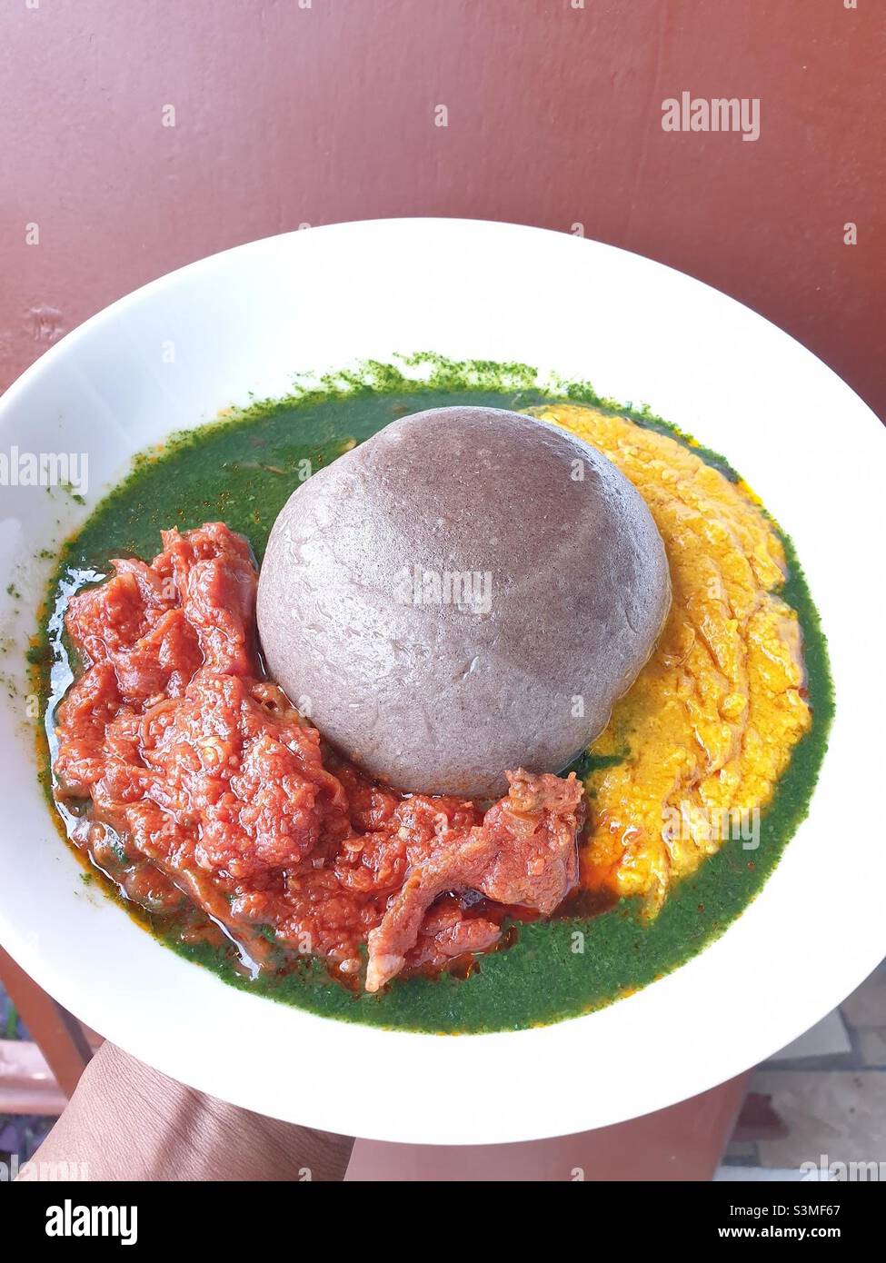 Amala, a dried yam paste dumpling, and abula. Abula is a trio of sauces