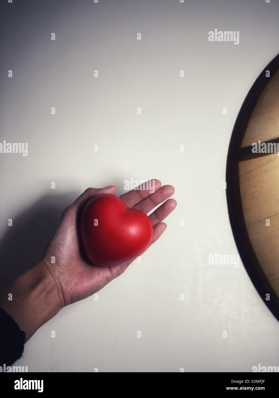 A woman holding a heart shaped. - Smartphone Captured Stock Image
