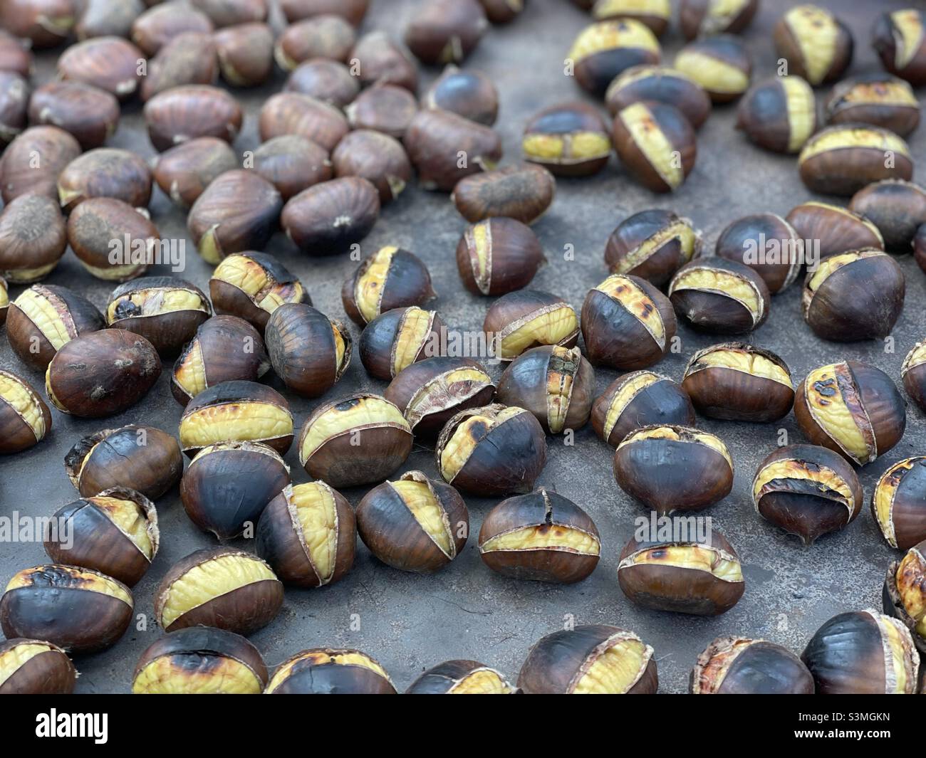 Chestnuts roasting at an outside food market in Italy Stock Photo