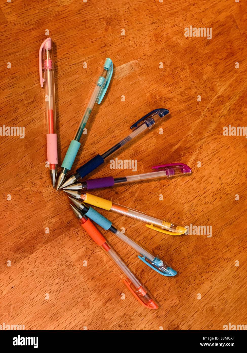 Colorful pens against brown background. - Smartphone Captured Stock Image