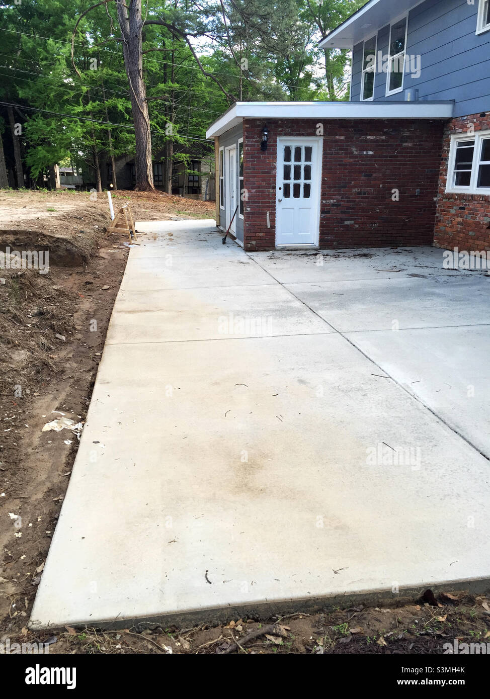 Newly poured cement patio at a house being remodeled Stock Photo Alamy