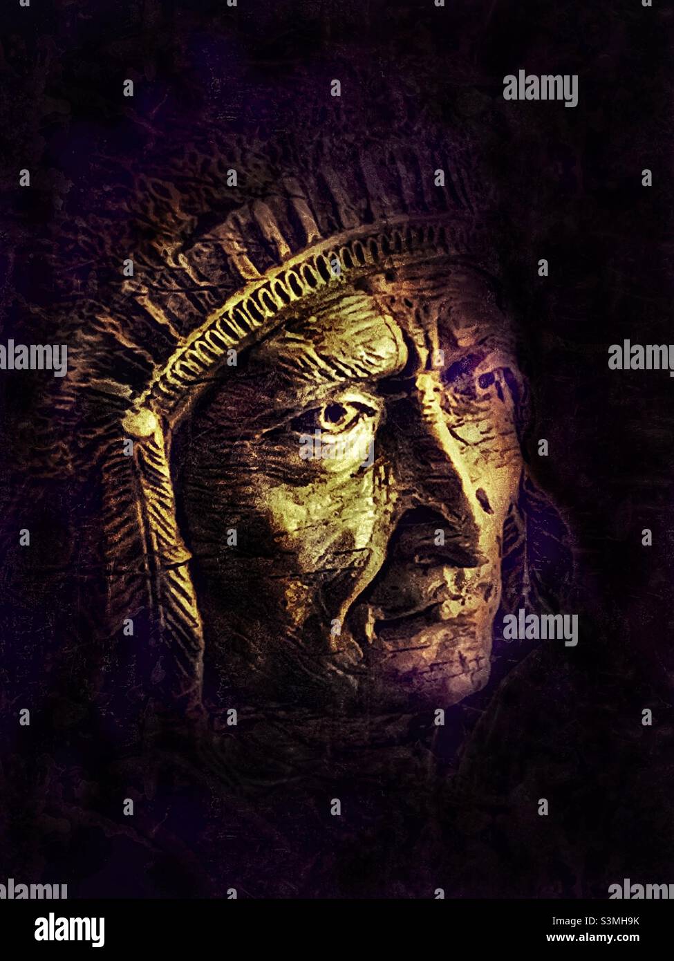 Native American sculpture/carving hangs inside a home as wall art and home decor. Original photo has been digitally altered via IOS apps for artistic effect. - Smartphone Captured Stock Image