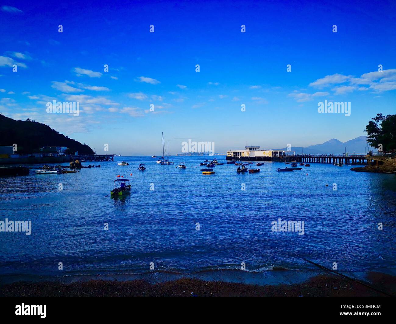 Yung Shue Wan bay and pier on Lamma island in Hong Kong. - Smartphone Captured Stock Image