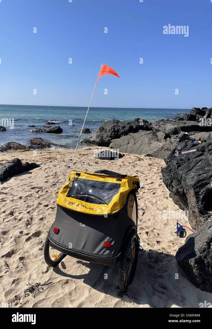 Burley Cub child bike trailer at beach Stock Photo Alamy
