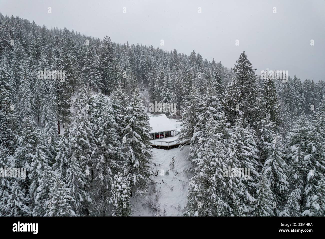 Mountainside chalet in the snow covered Cascade mountains Stock Photo