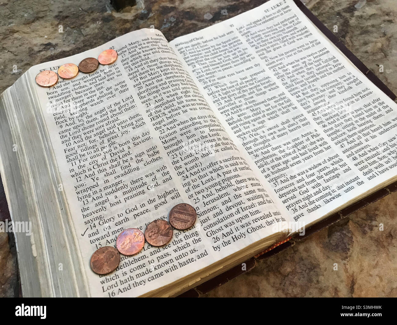 opened Bible turned to the New Testament chapter of Saint Luke. Stock Photo