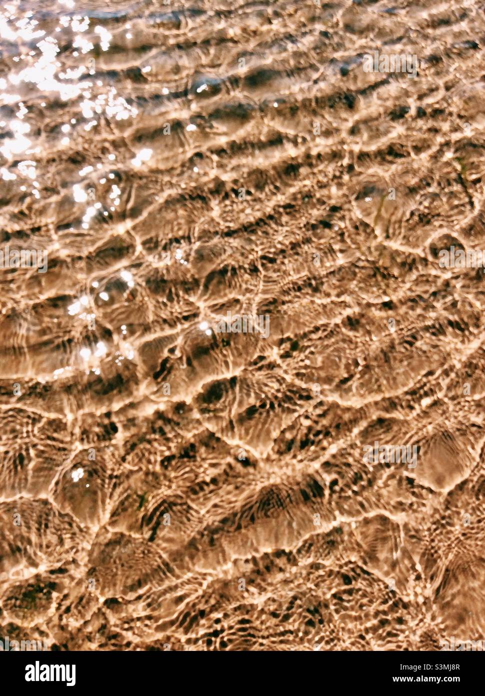 Shimmering sea ripples on the sand - Seamill Beach, Seamill, West Kilbride, North Ayrshire, Scotland Stock Photo