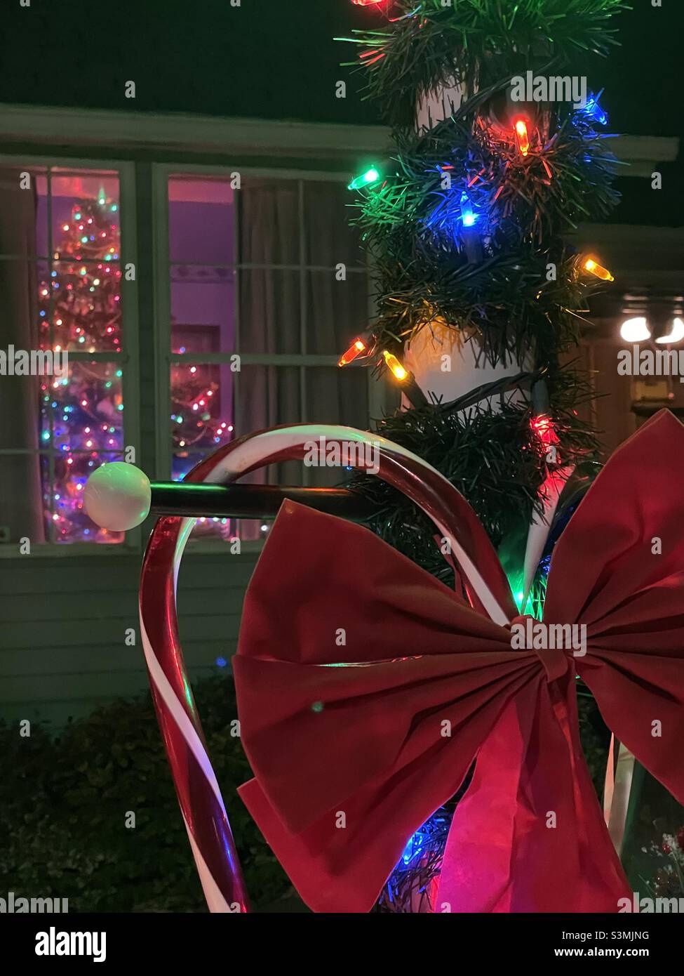 A home in the Salt Lake valley of Utah, USA has their outdoor Christmas decorations up and glowing for the season. - Smartphone Captured Stock Image