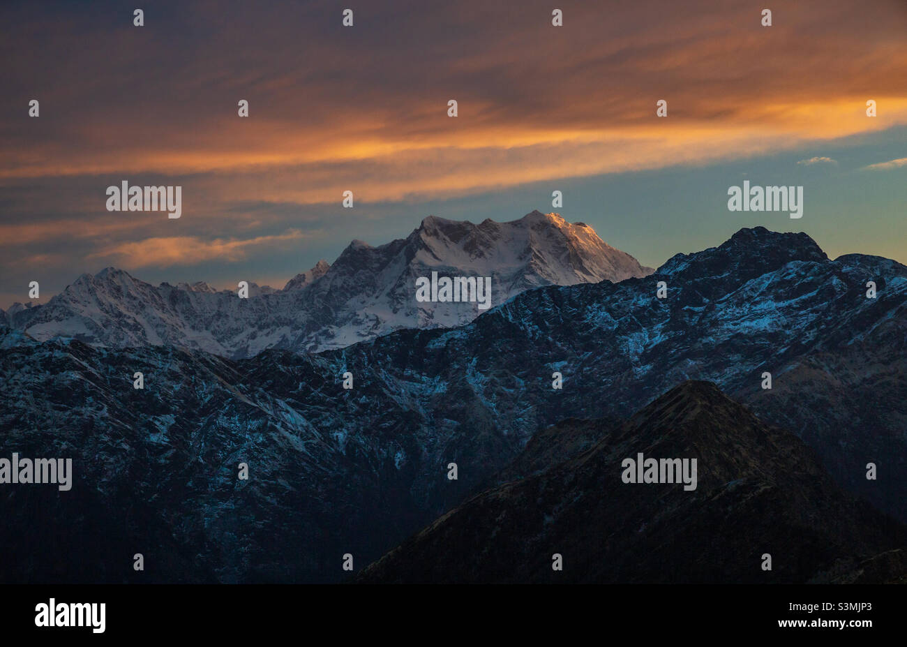 First Sunlight on Chaukhamba mountain in Himalayan range in Uttarakhand, India - Smartphone Captured Stock Image