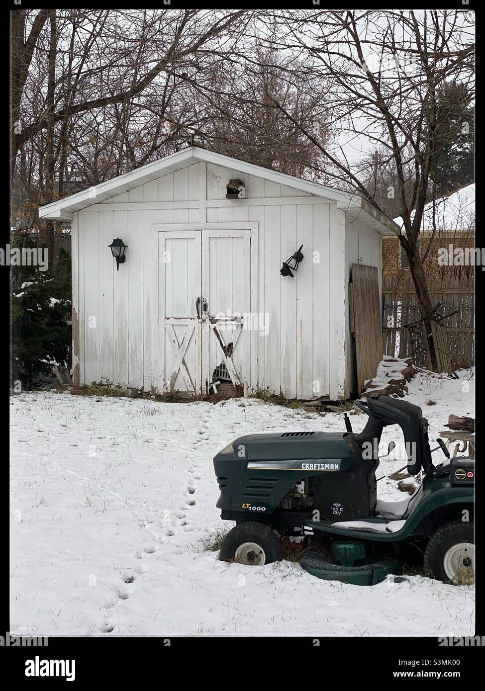 Old shed in a back yard in snow Stock Photo