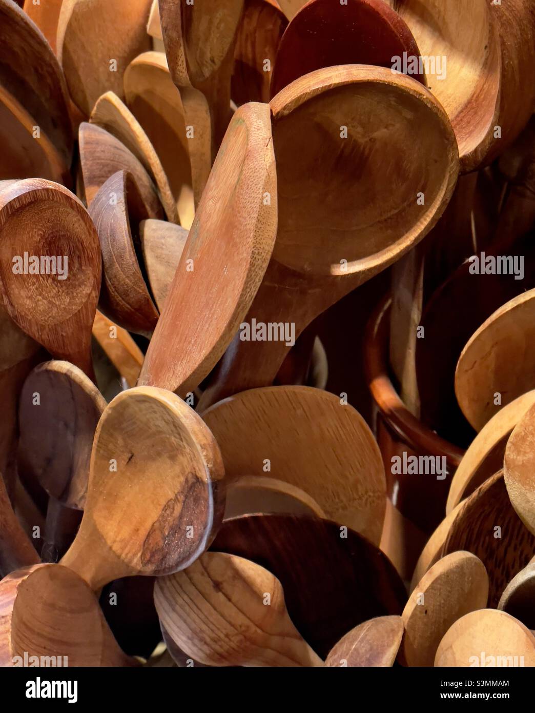 An international collection of souvenir wooden spoons - Smartphone Captured Stock Image