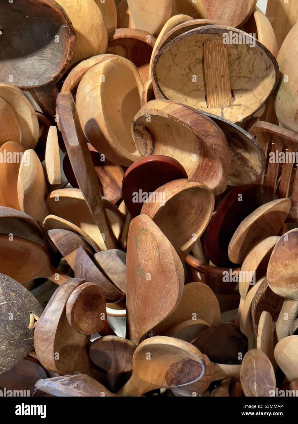 An international collection of souvenir wooden spoons including some made of coconut shell - Smartphone Captured Stock Image