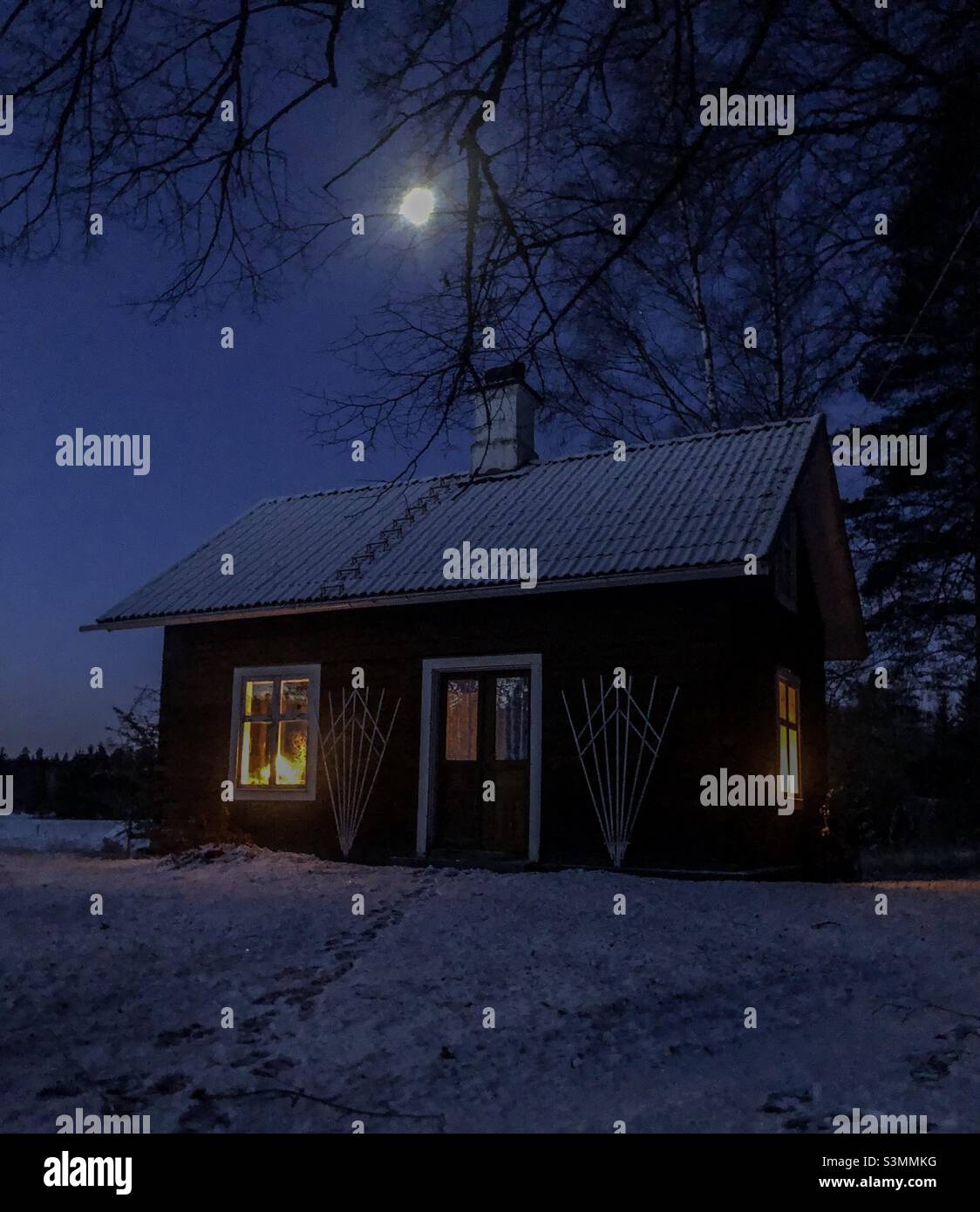 Traditional Swedish log house from the 19th century. Cold winter morning with snow and full moon, January, 8 o'clock in the morning. - Smartphone Captured Stock Image