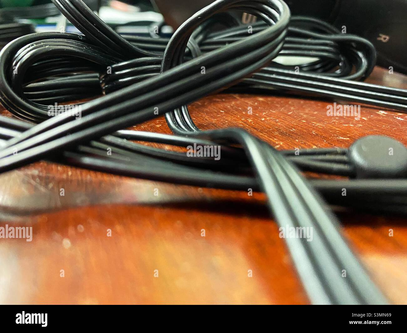 Tangled head phone cords on a desk Stock Photo Alamy