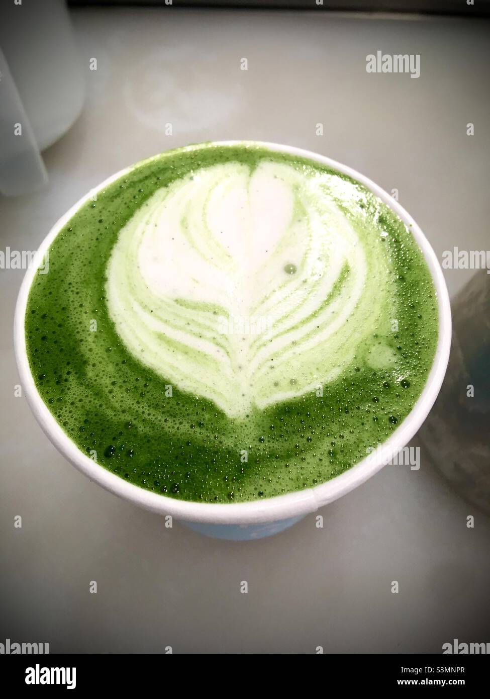 Matcha Latte made with almond milk on a white background Stock Photo