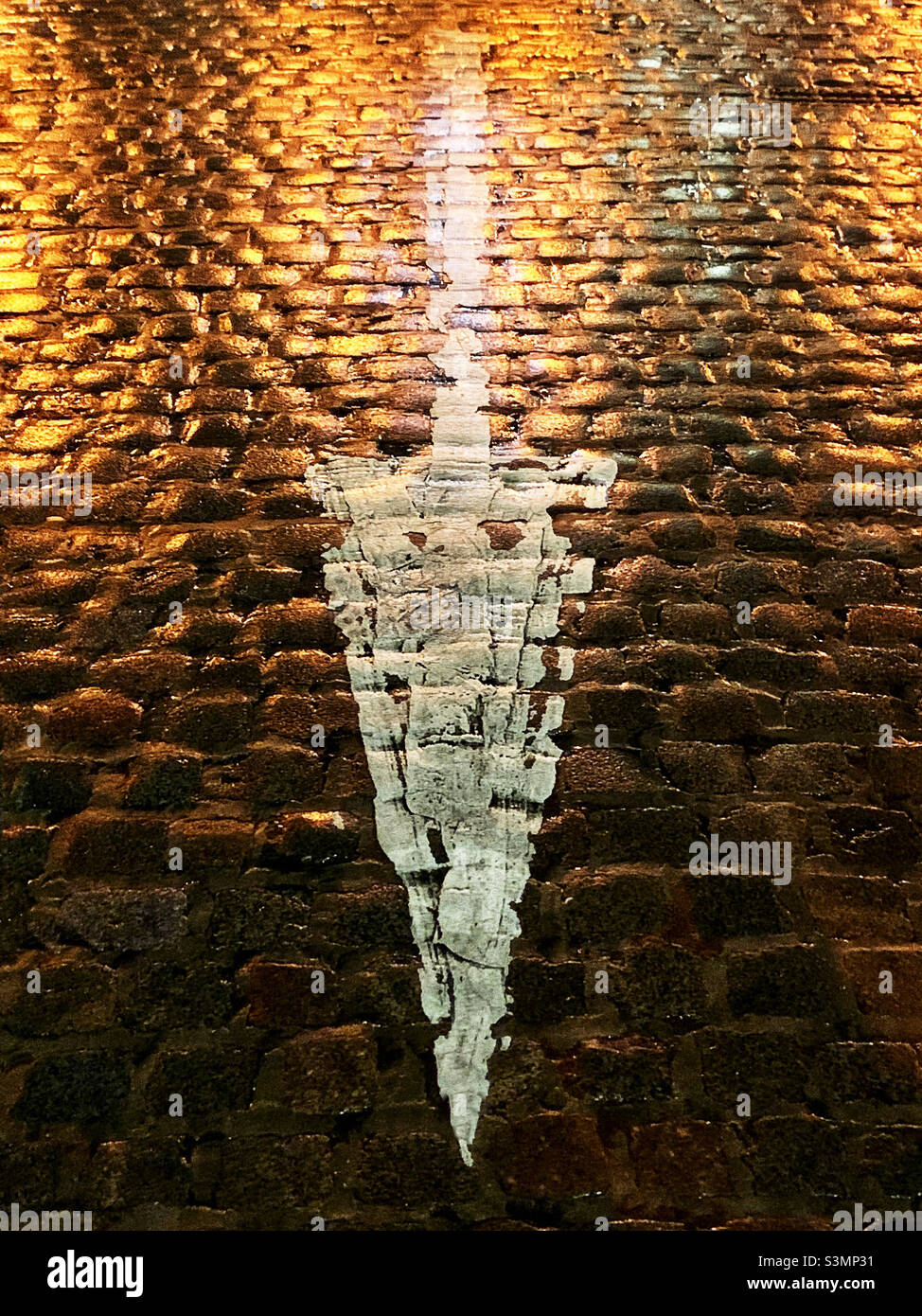 White arrow on cobblestones - Smartphone Captured Stock Image