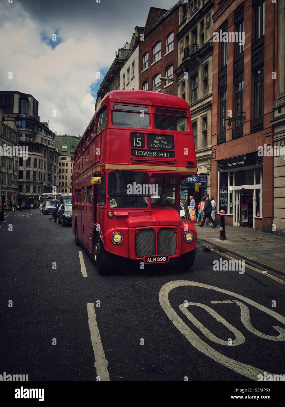 Old traditional red double decker bus on a London street. Stock Photo