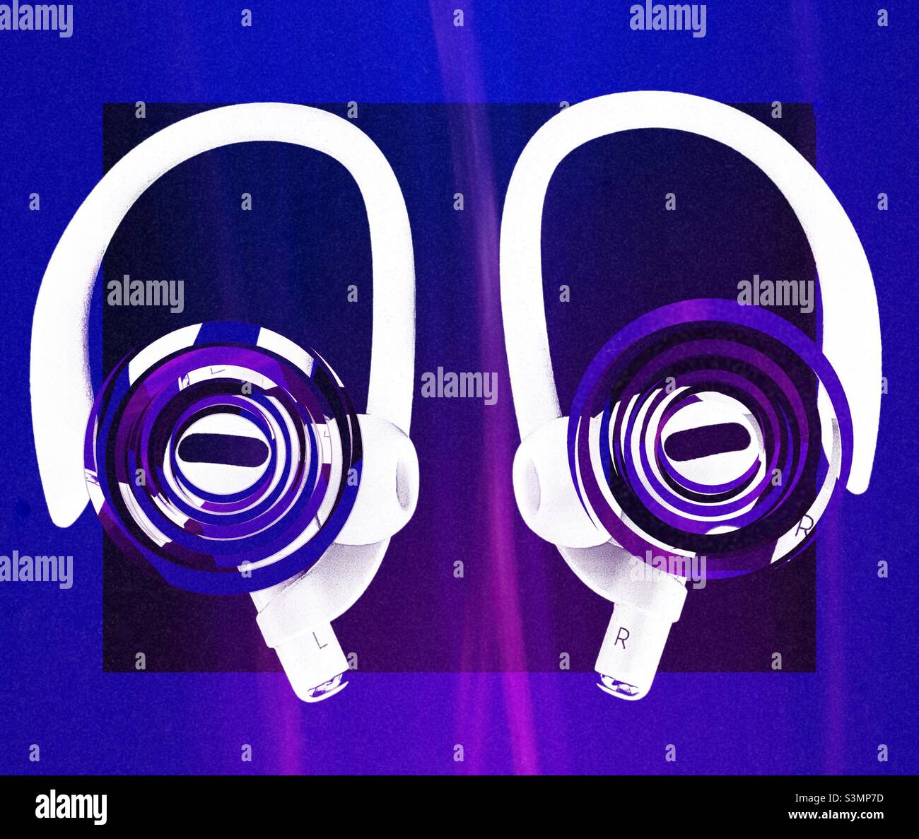 Newest pair of Apple AirPods Pro, with ear hook accessories attached. Colored frame, background and rippled effects (representing sound) have been added digitally for artistic effect. - Smartphone Captured Stock Image