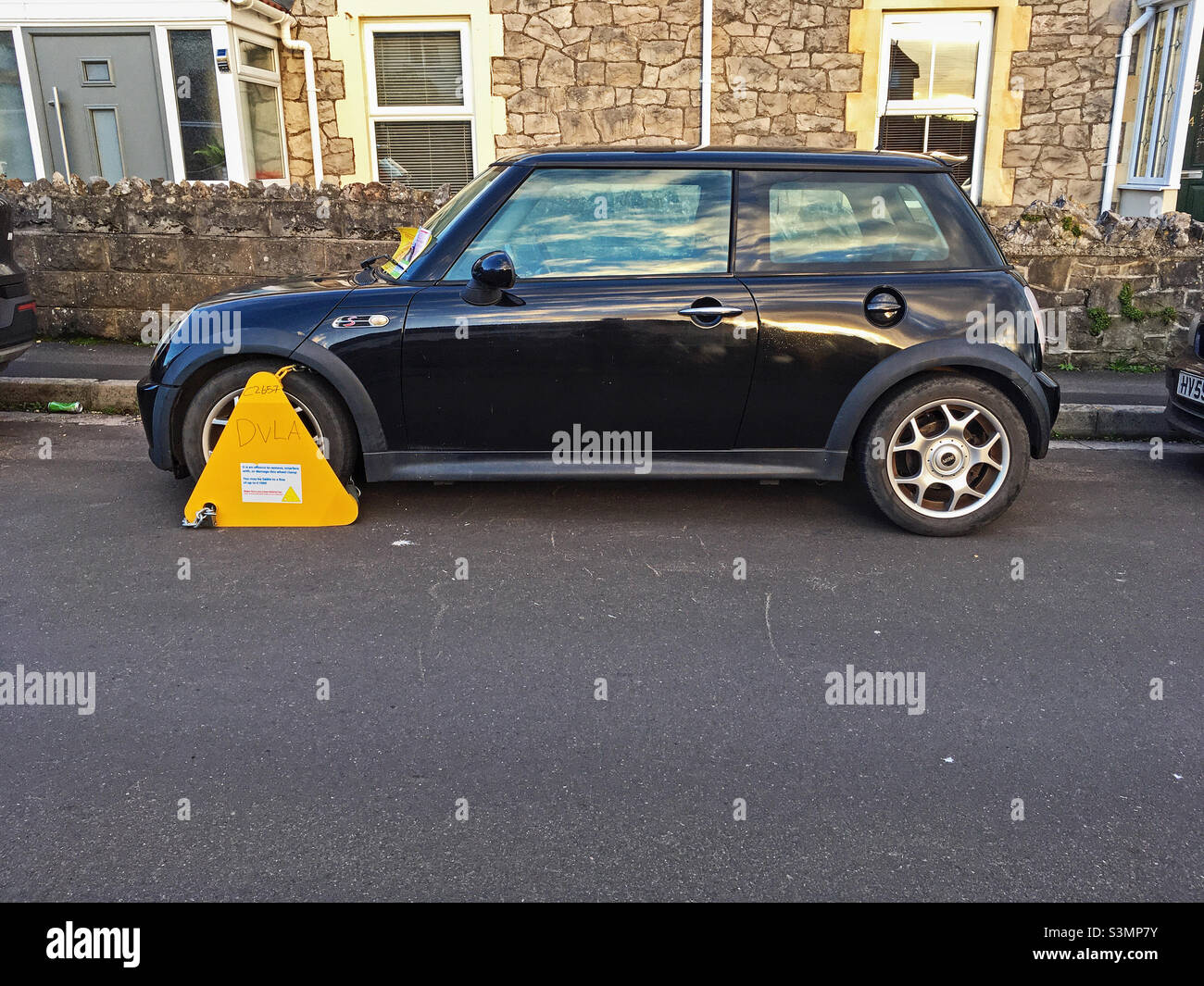 A car which has been wheel clamped by the Driver and Vehicle Licensing Agency. The DVLA uses