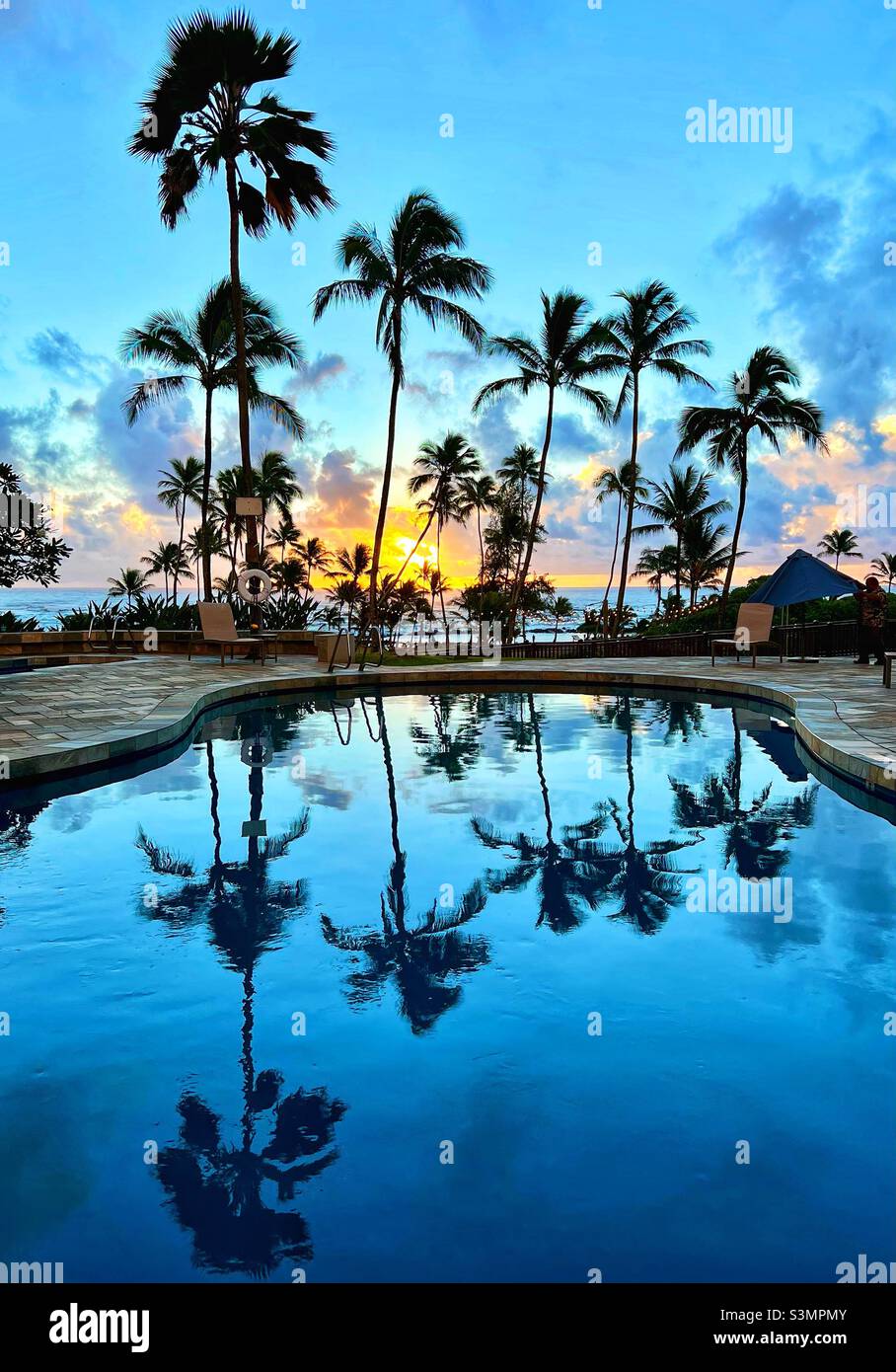 Sunrise reflecting in Hilton hotel pool at Wailua Bay, Kapaa, Kauai, Hawaii where the Wailua River meets the ocean at Lydgate Beach Park. - Smartphone Captured Stock Image