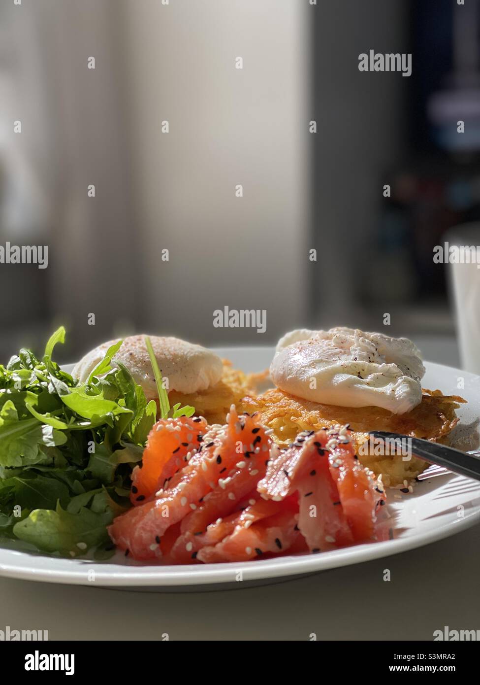 breakfast of potato pancakes, poached eggs, arugula, red fish - Smartphone Captured Stock Image