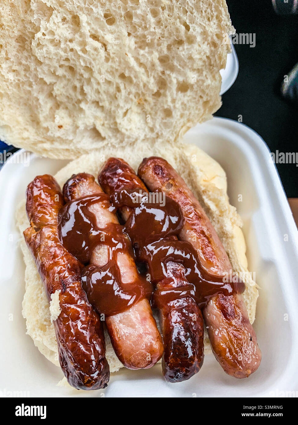 Sausage sandwich with brown sauce in a bread cake Stock Photo