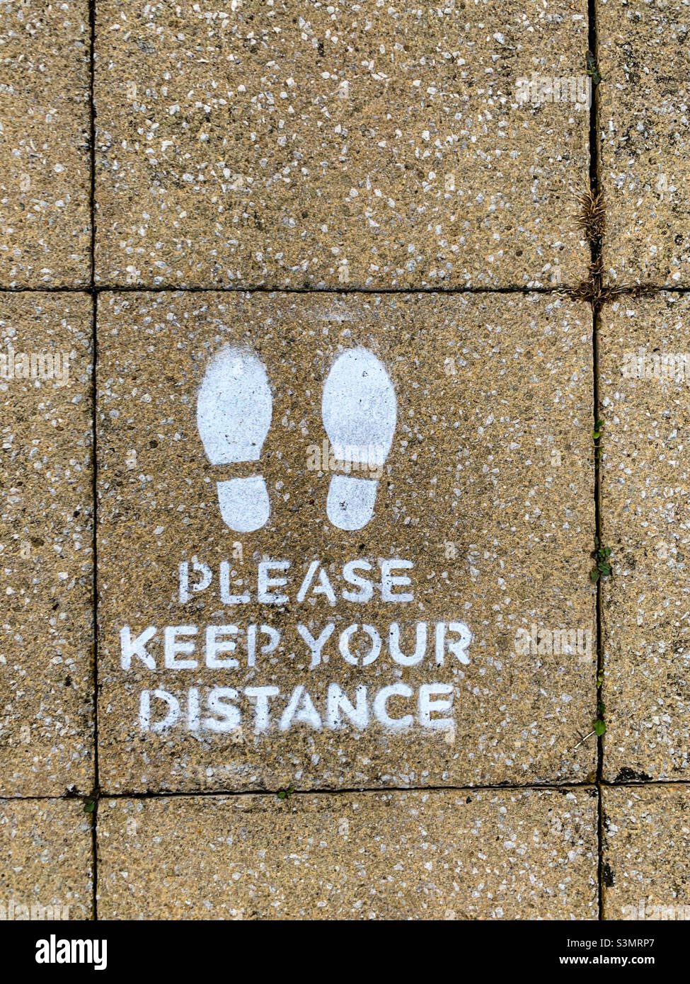 Please keep distance on pavement Stock Photo