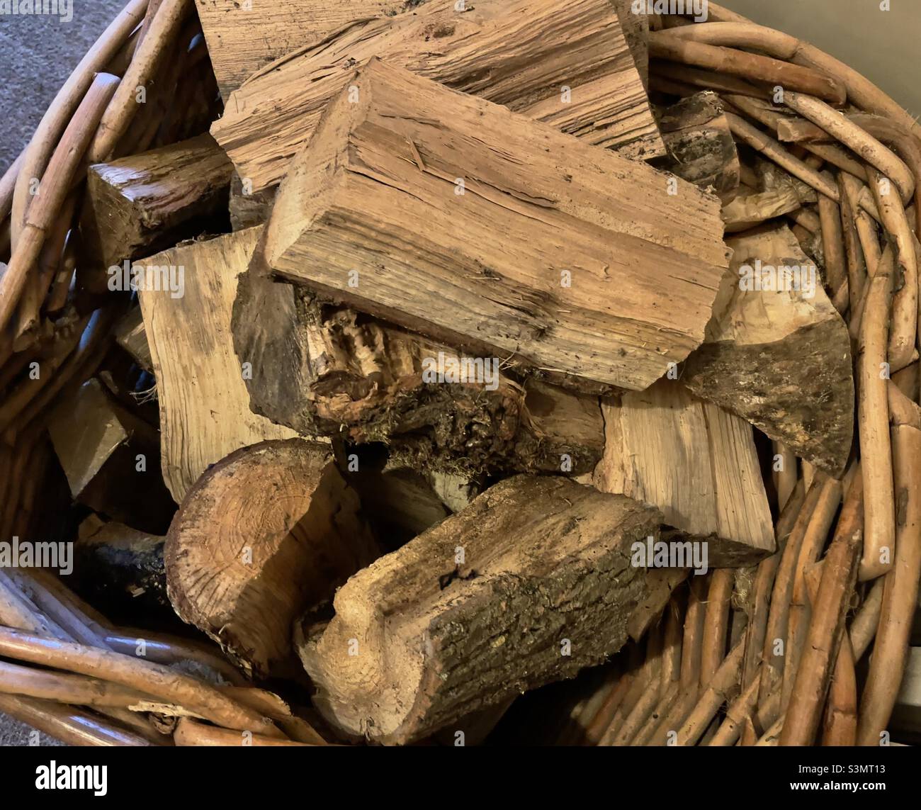 Hey close up of a basket of split logs, fuel for open fires - Smartphone Captured Stock Image