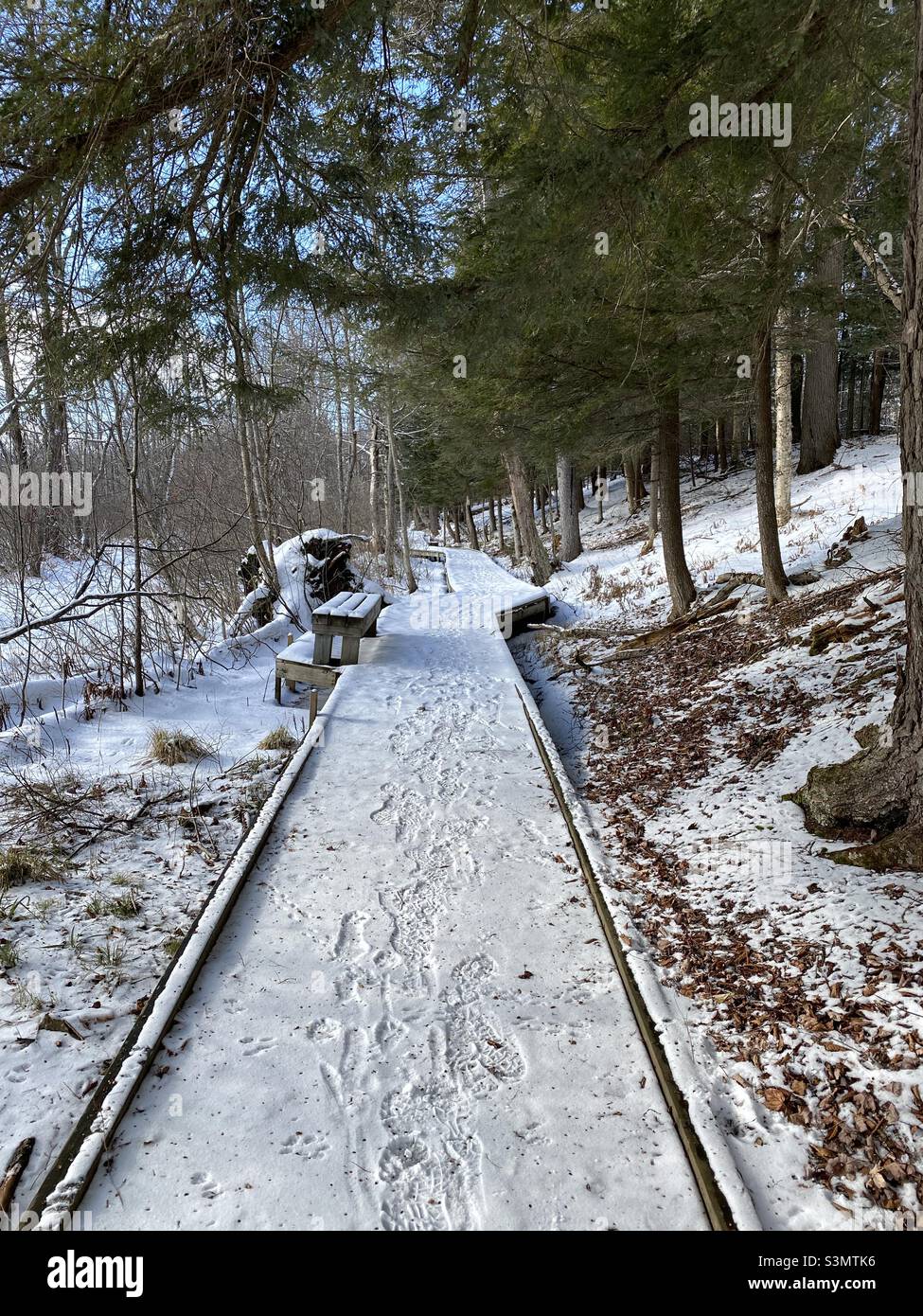Snow covered boardwalk in the Sacandaga River pathway in Speculator, NY Stock Photo