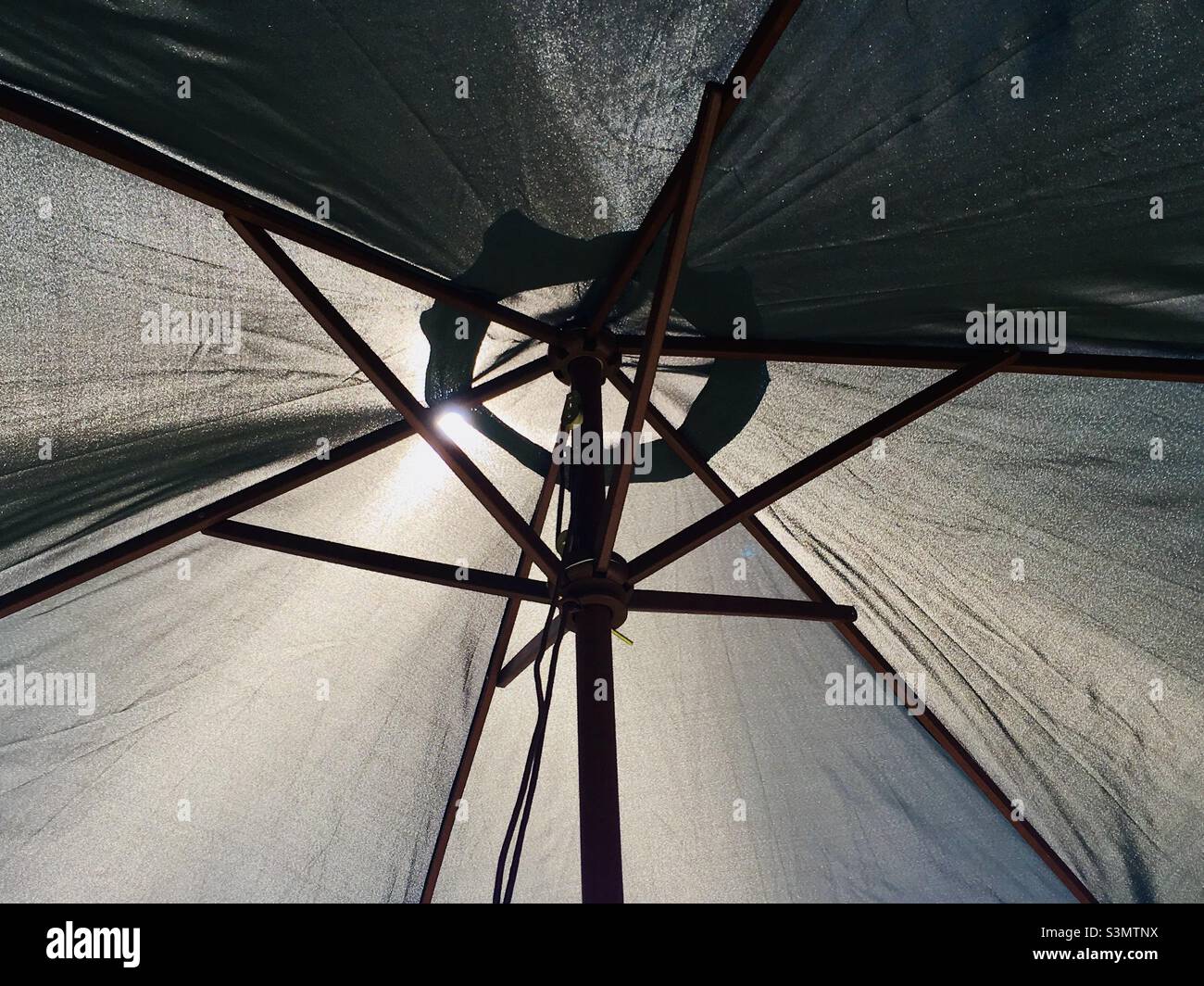 Huge patio umbrella providing shade from the sun Stock Photo
