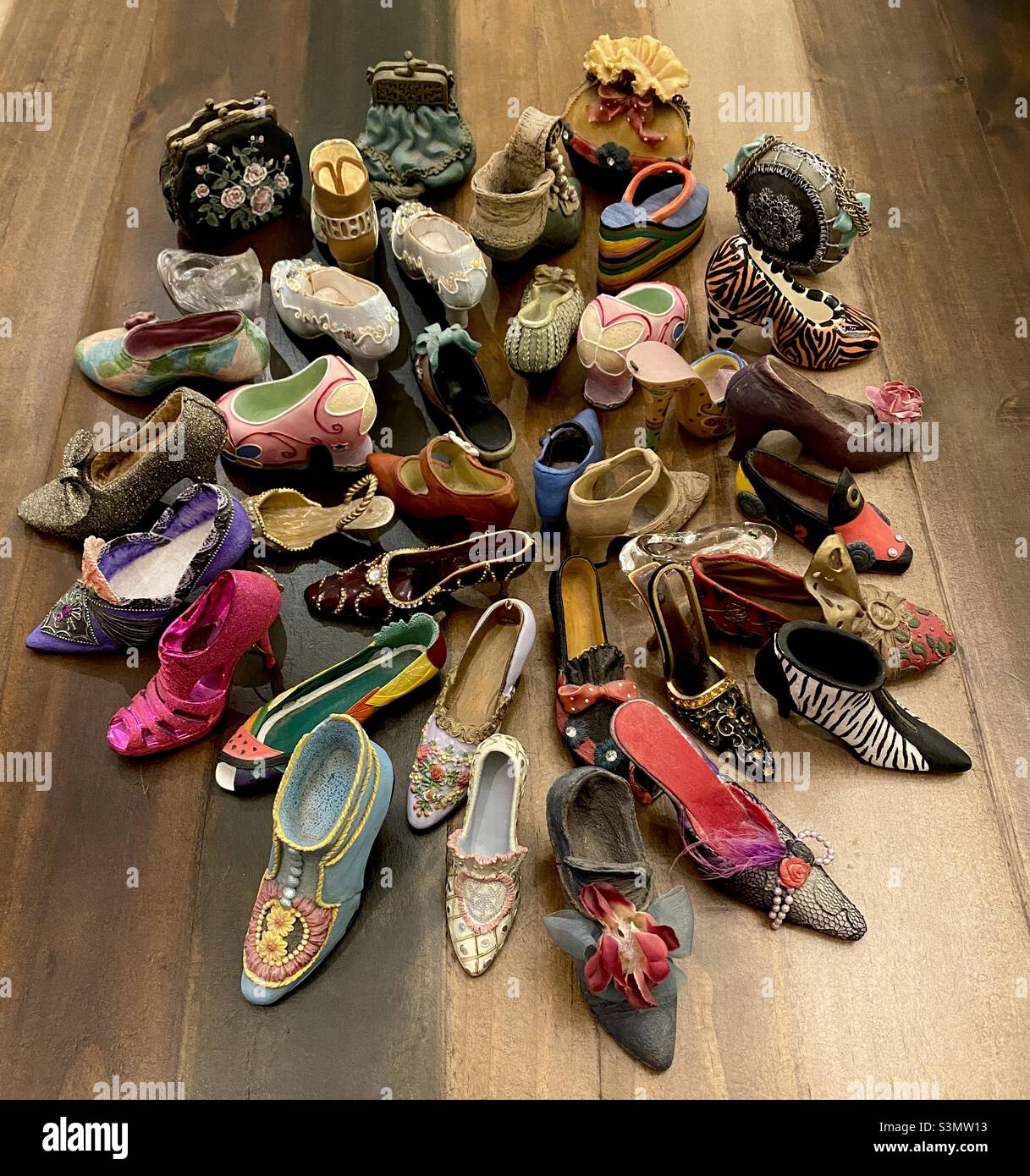 A collection of tiny miniature shoes and handbags. - Smartphone Captured Stock Image
