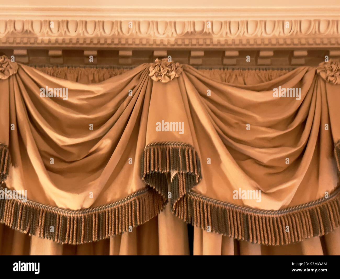A detail of a swagged drape pelmet in a country house hotel - Smartphone Captured Stock Image