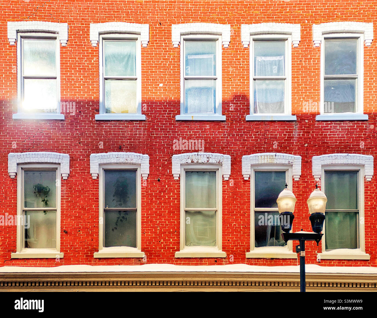 Morning sunlight on windows of a brick building - Smartphone Captured Stock Image