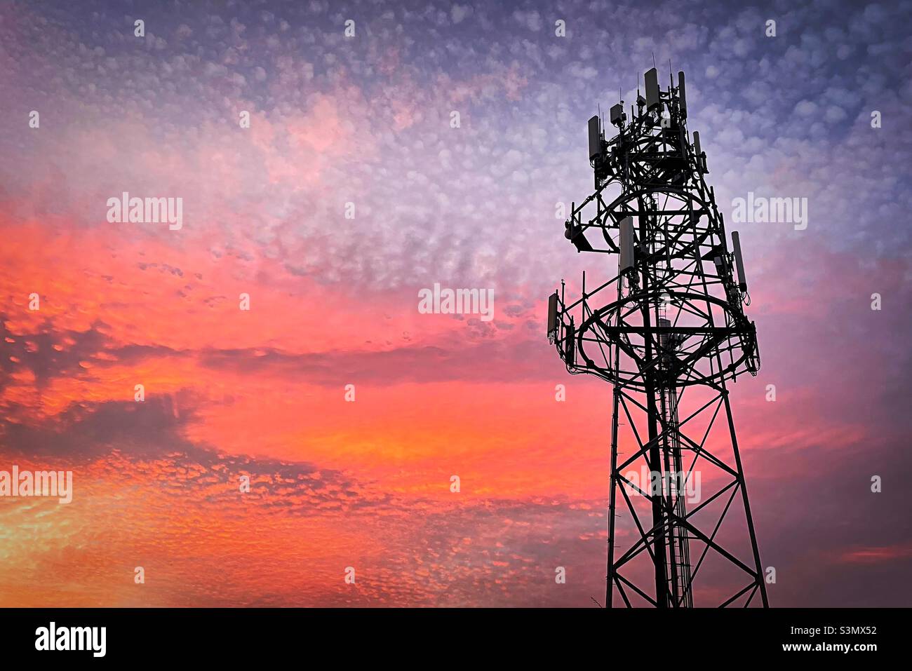 ‘Transmission of Light’ a transmitter stands tall in front of the most stunning sunset Stock Photo