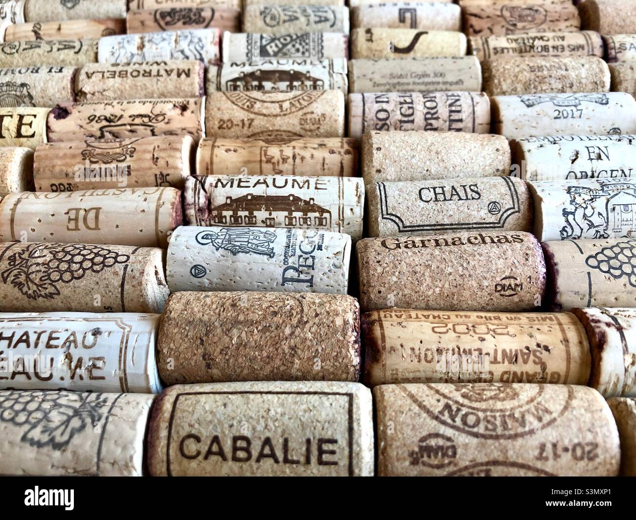 Display of assorted wine corks laid out in rows including quality fine French wines. Stock Photo