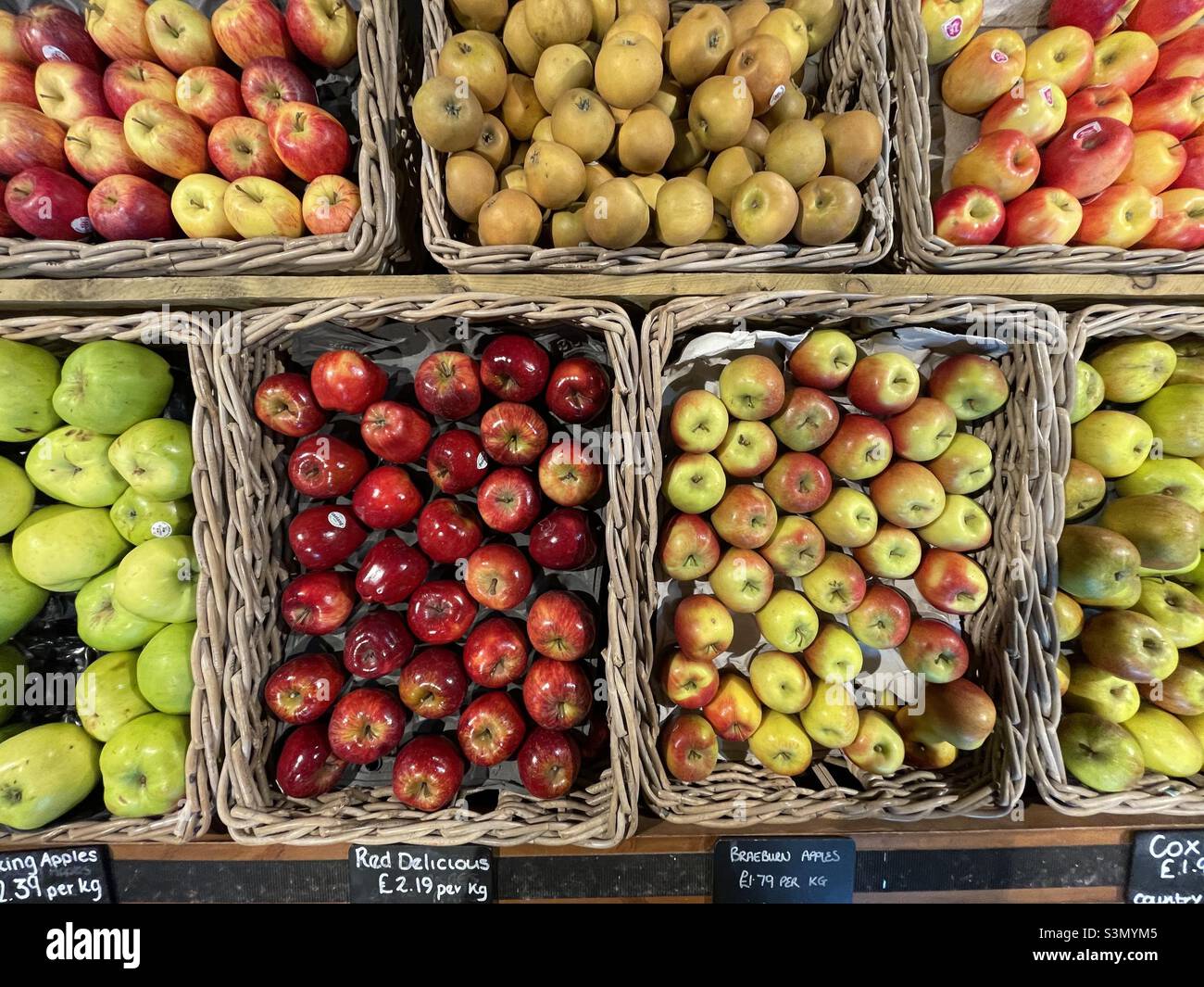 Baskets of different varieties of apples on sale in a Leicestershire farm shop Stock Photo