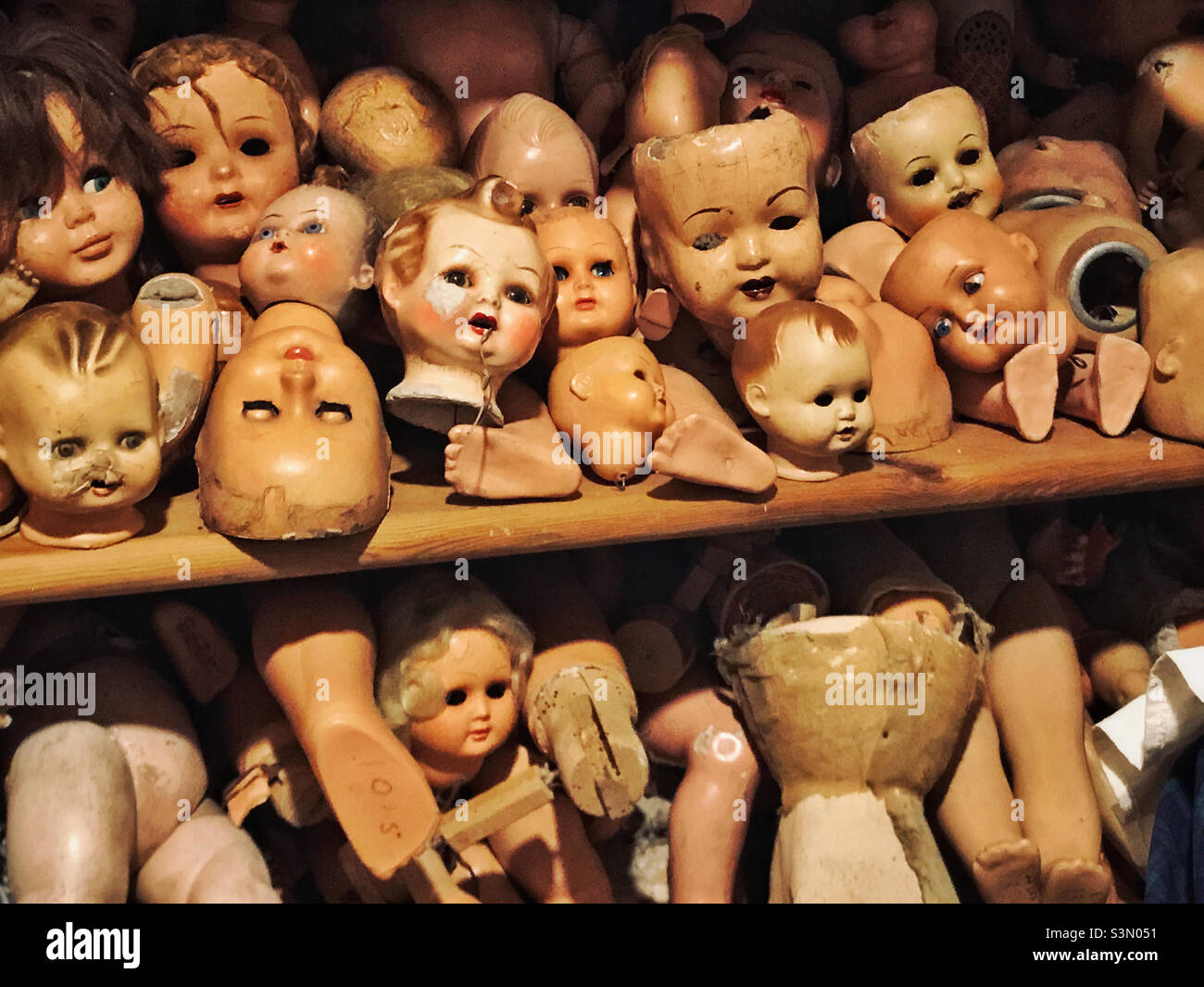 A selection of dolls heads & body parts. A slightly macabre scene from the Doll’s Hospital in Lisbon, Portugal. Broken or damaged dolls are repaired & given a new lease of life. Photo ©️ COLIN HOSKINS - Smartphone Captured Stock Image