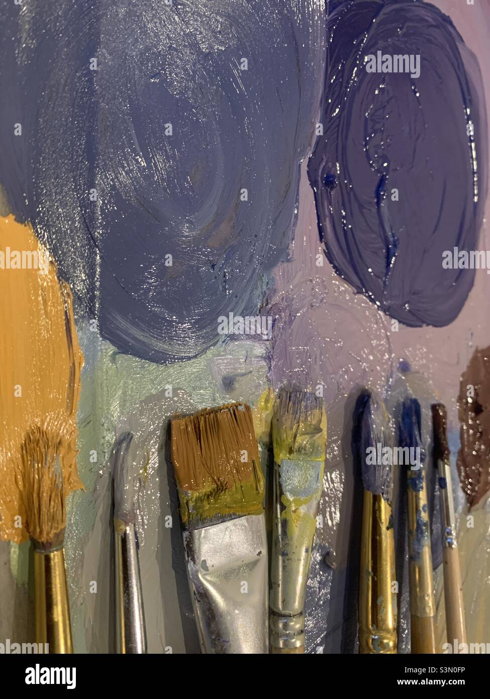 Paint brushes and palette in lilac and purple - Smartphone Captured Stock Image