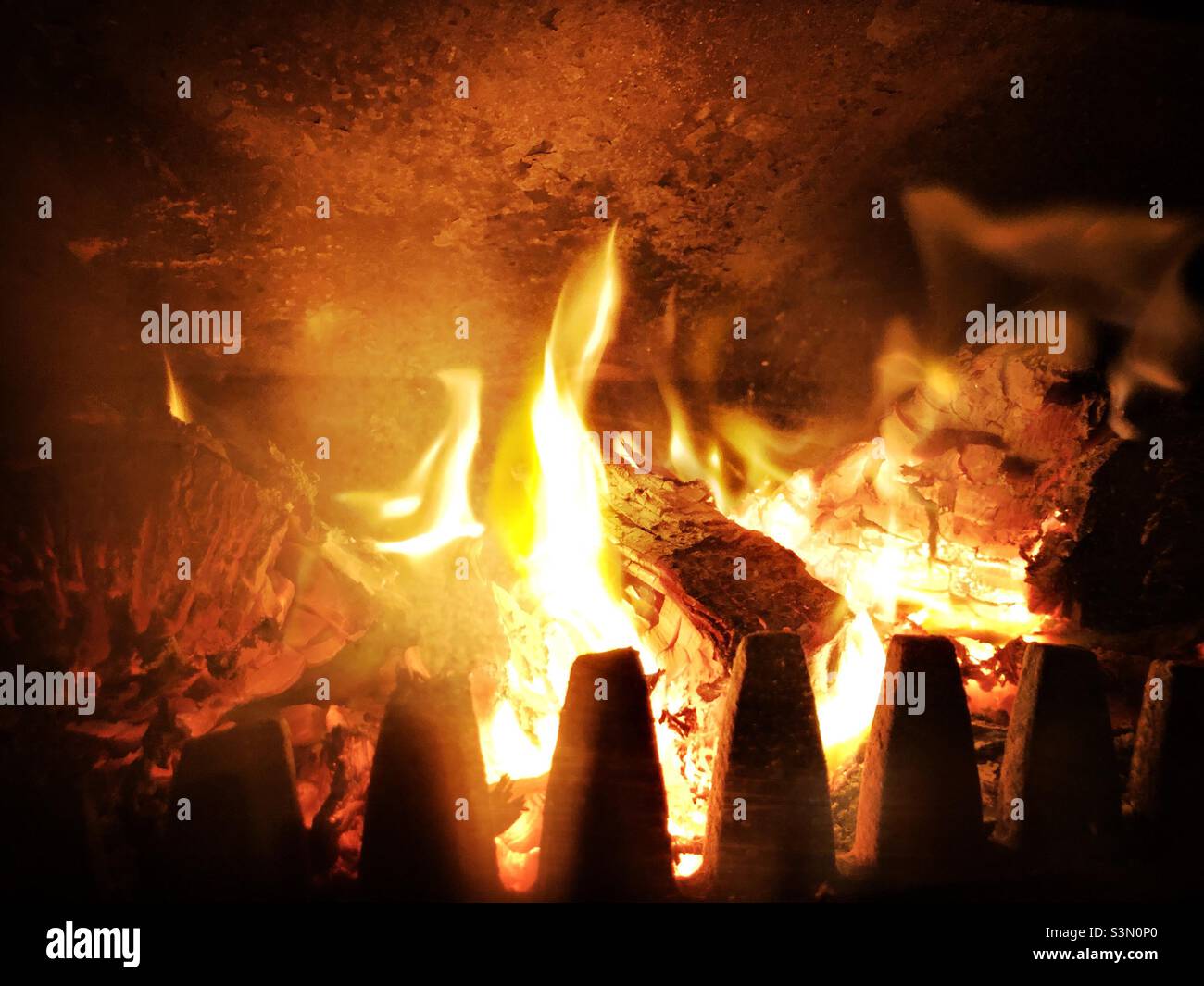 Wood burning in a wood burning stove - Smartphone Captured Stock Image