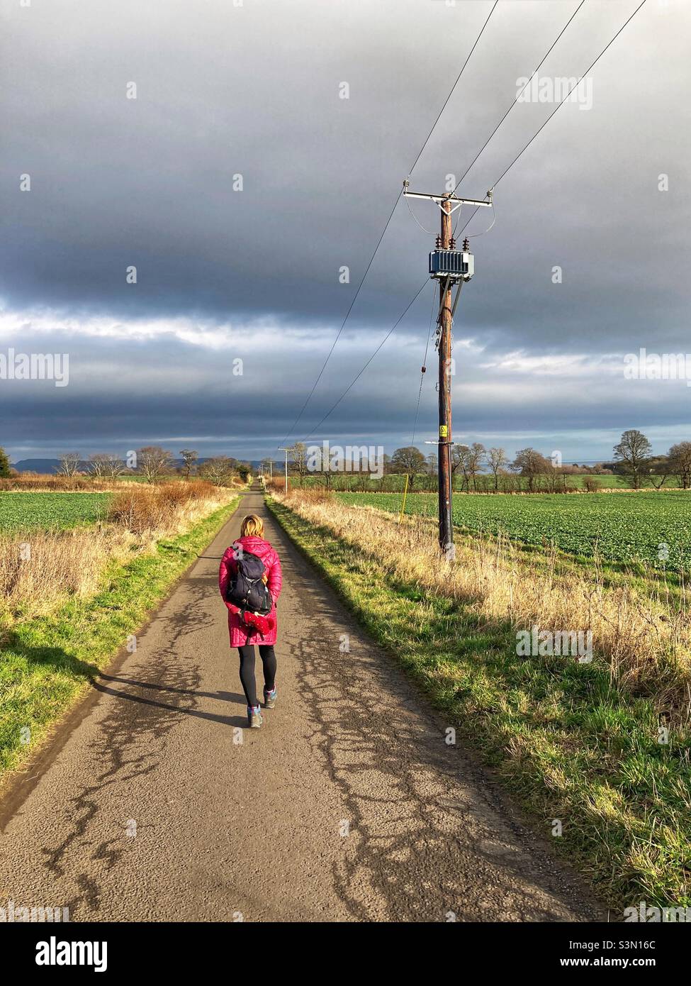Woman Walking on a country road - Smartphone Captured Stock Image