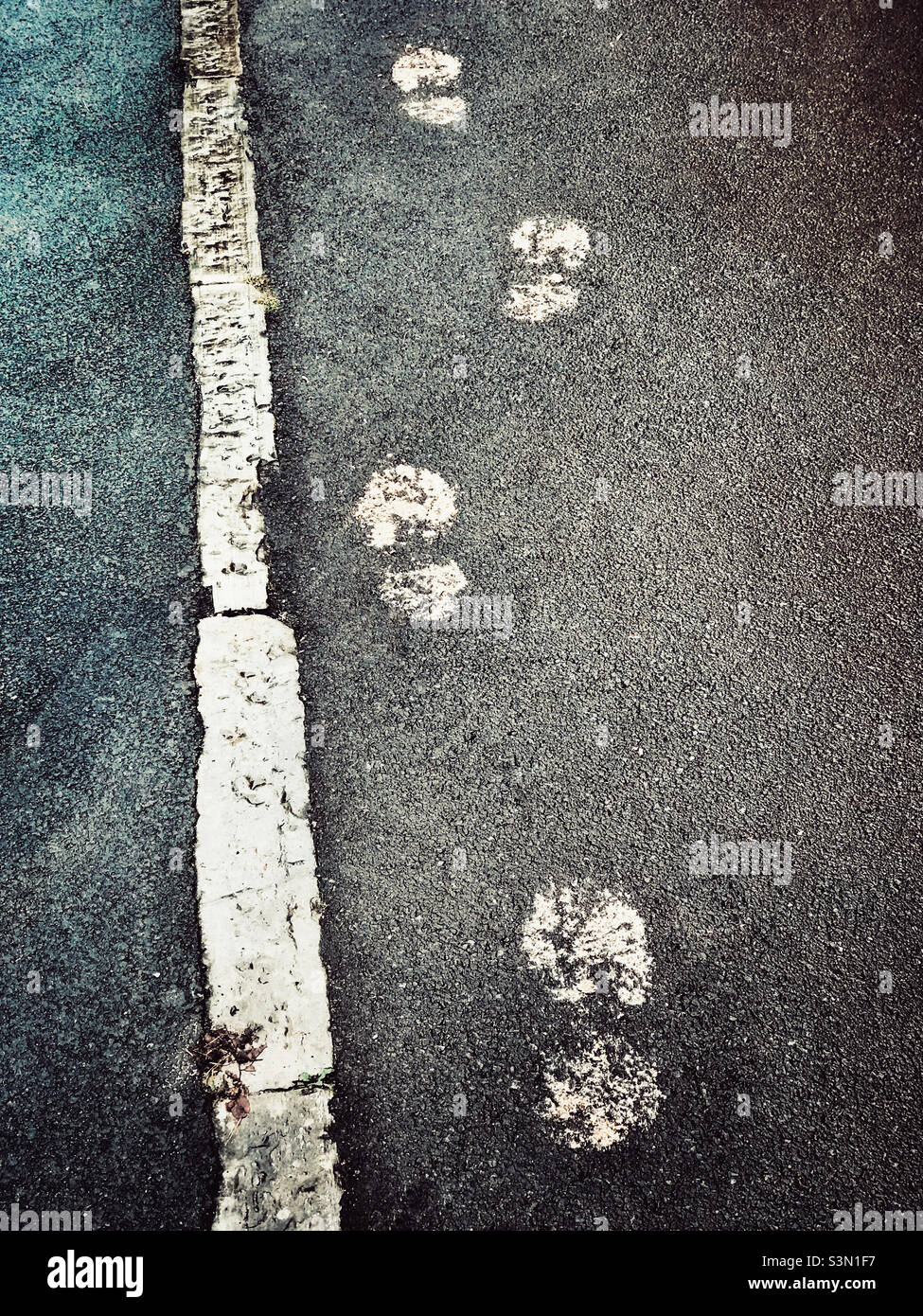 Footprints on a pavement made with paint - Smartphone Captured Stock Image