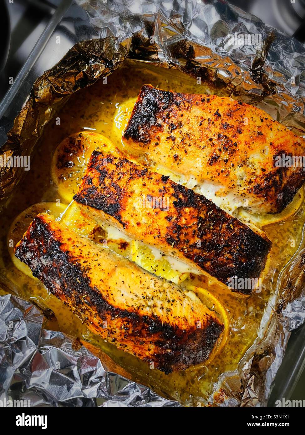 Close-up of broiled salmon fillets fresh out of the oven, 2022, USA - Smartphone Captured Stock Image