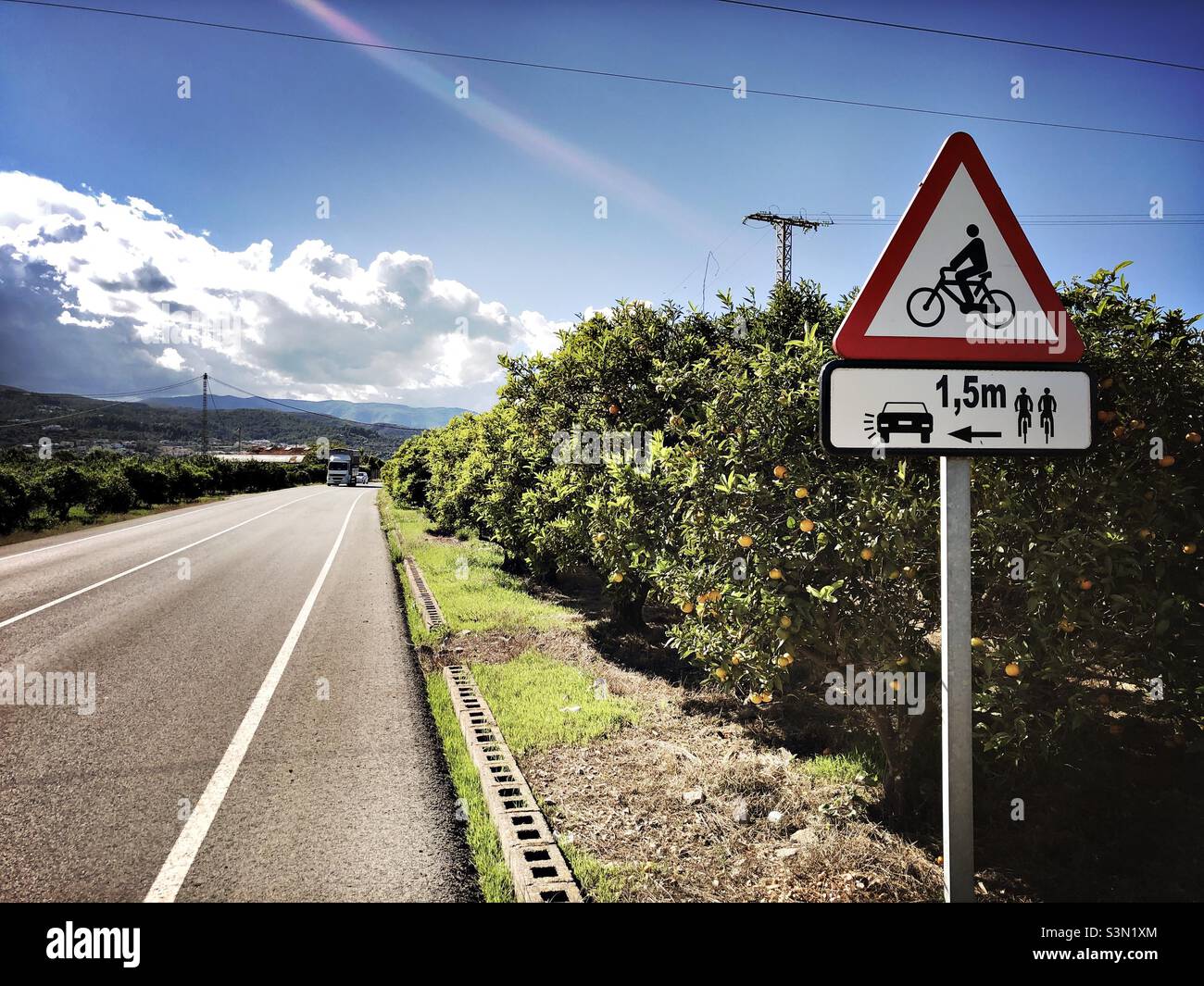 Road sign warning an out keeping a distance from cyclists on the road, Spain - Smartphone Captured Stock Image