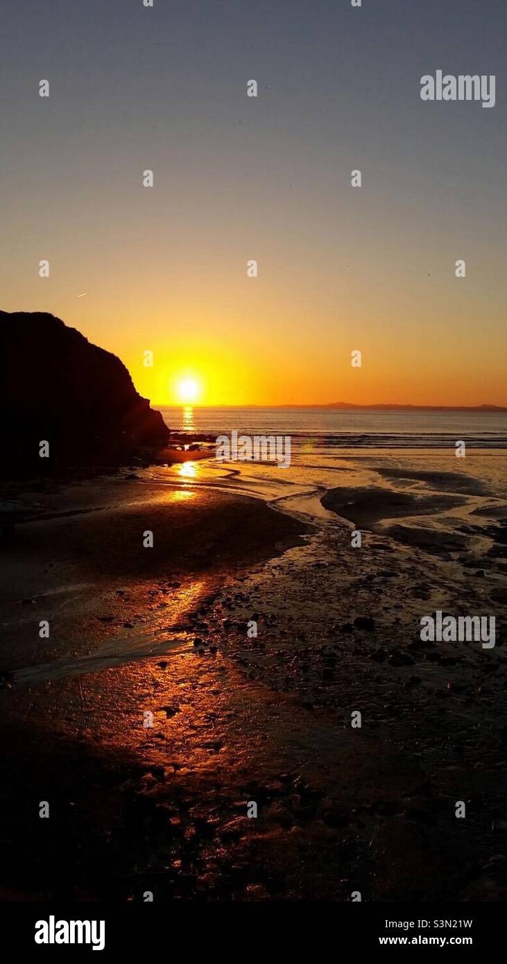 Rich amber sunset over the Pembrokeshire coast in West Wales UK Stock Photo