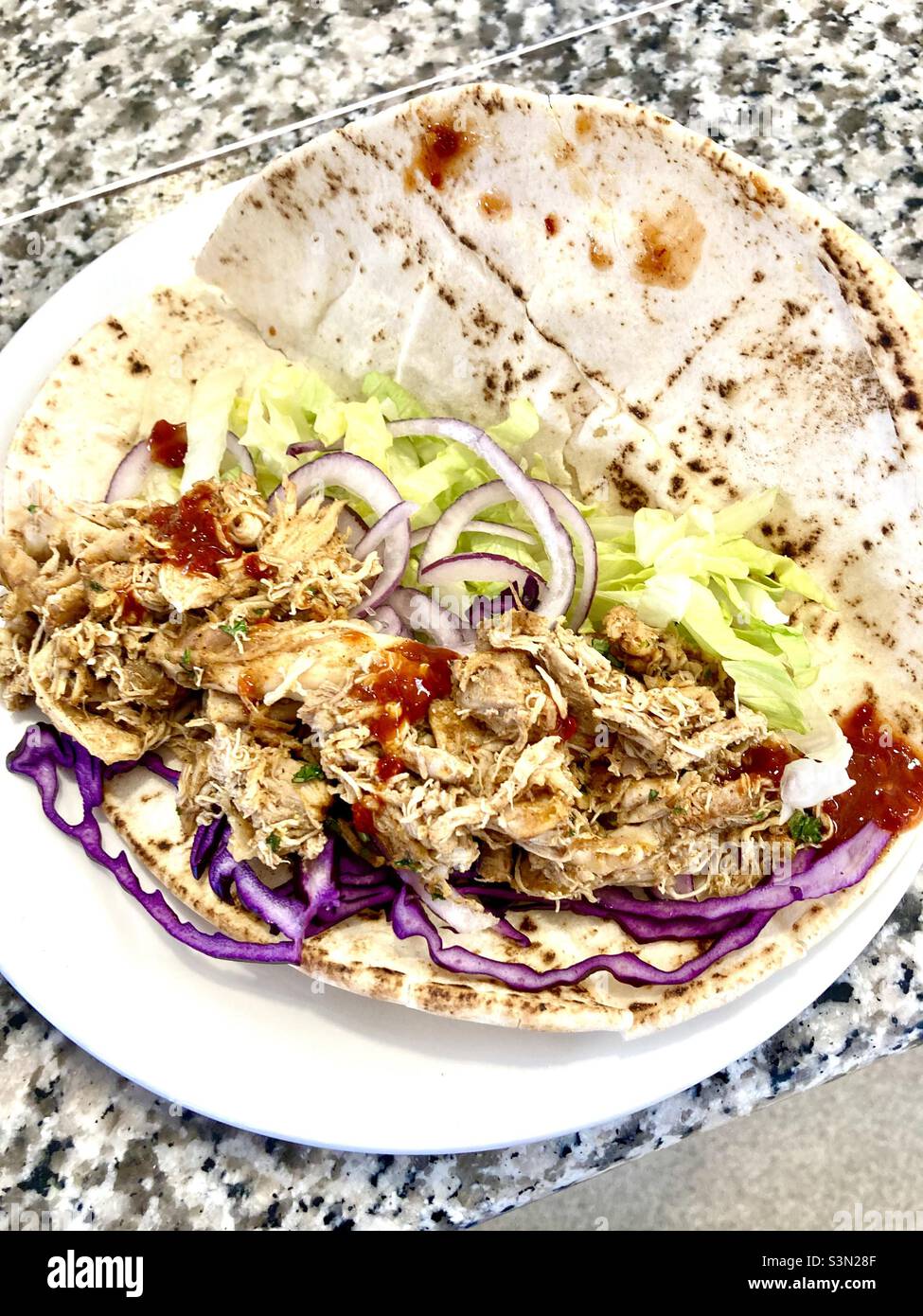 Chicken and salad flat bread with chilli sauce Stock Photo Alamy