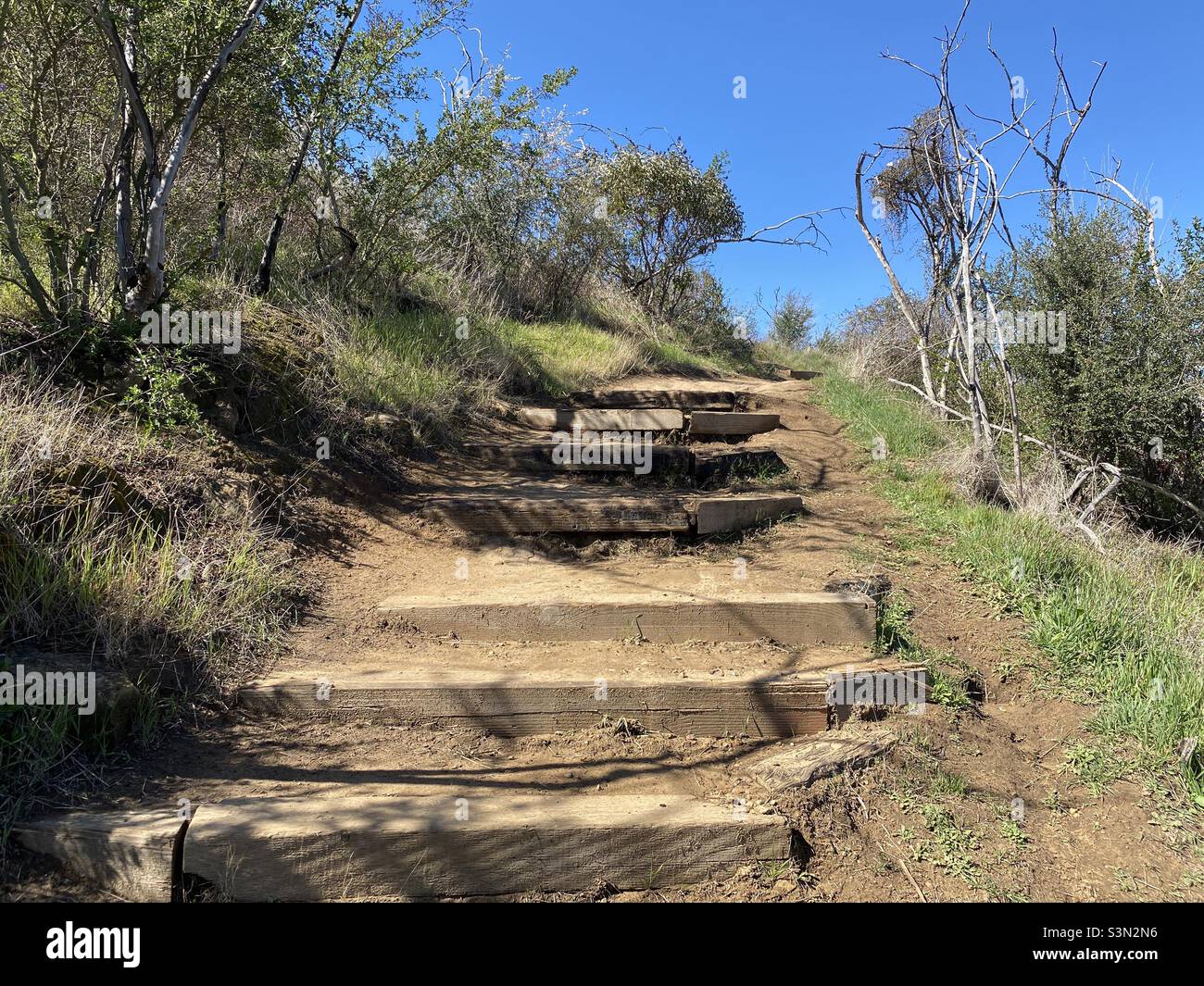 Steps on hiking trail in Santa Monica Mountains, Point Mugu State Park, with clear blue skies overhead Stock Photo