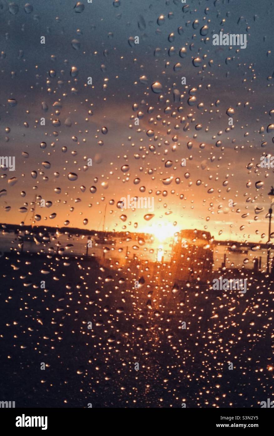 Sunset over the river from behind a rain covered car window pane Stock  Photo - Alamy