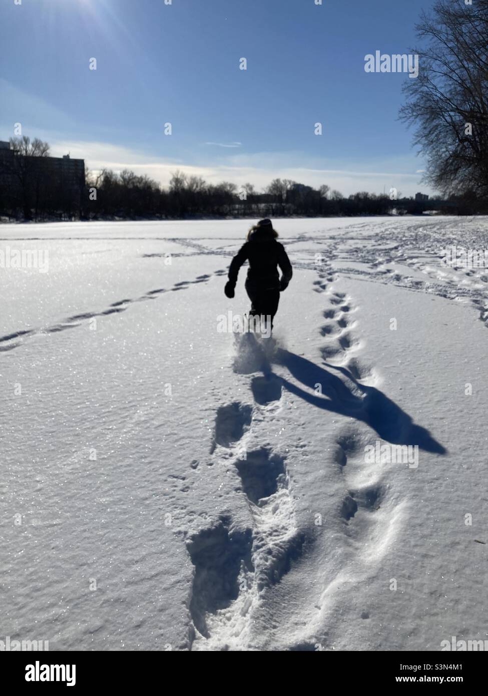 A beautiful day for snowshoeing on the Rideau River in Ottawa, Canada. - Smartphone Captured Stock Image