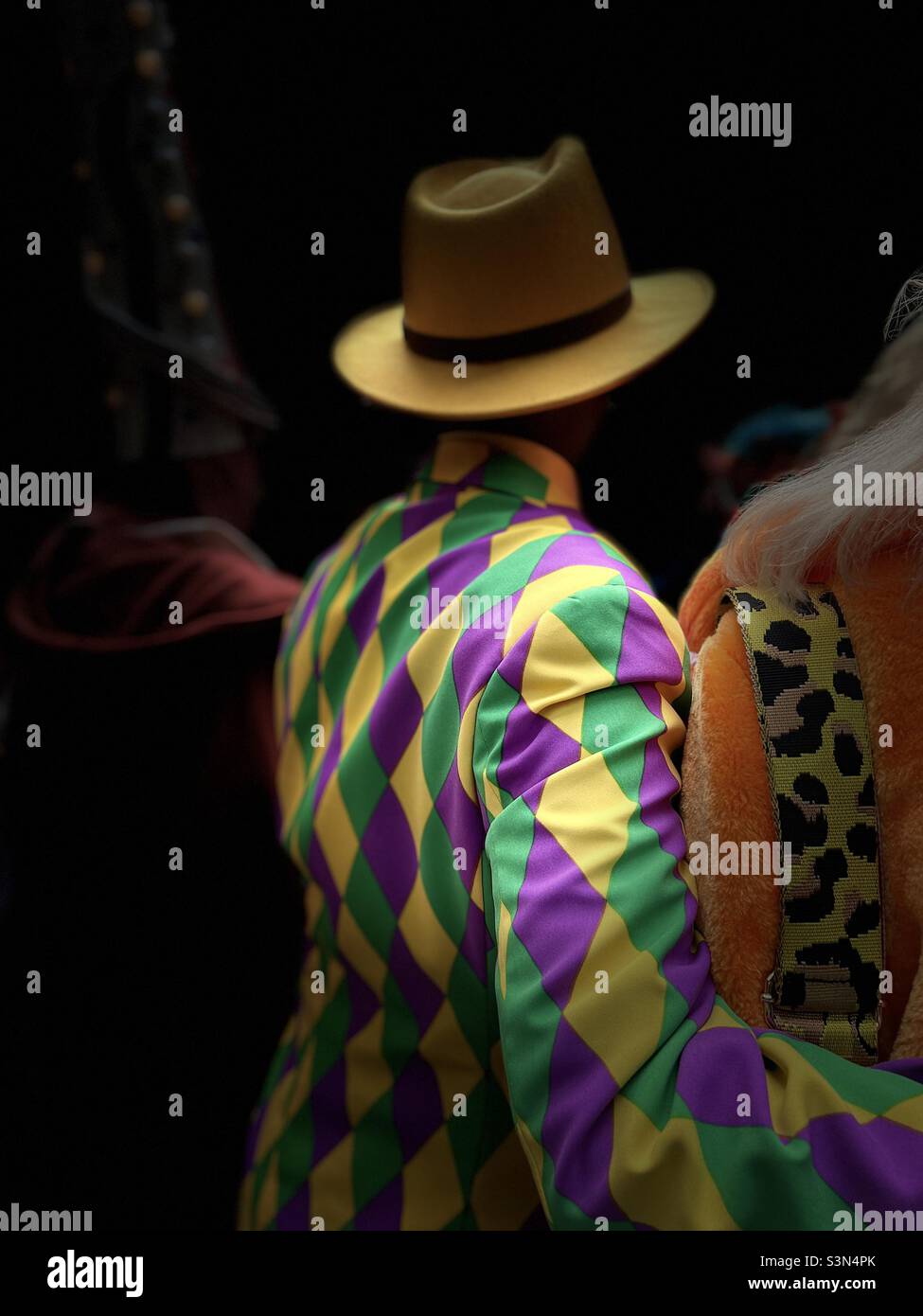 Brightly colored harlequin diamond pattern jacket on man London’s Spitalfields market colourwalk - Smartphone Captured Stock Image